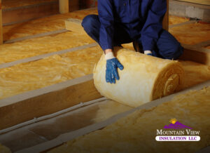 Professional installing underfloor insulation for optimal efficiency