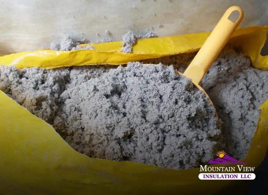 Installing cellulose insulation in an attic for energy efficiency.